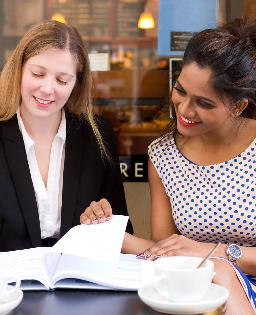 Two 30-somethings, an investment representative and client meet in a restaurant. Two 30-somethings, an investment representative and client meet in a restaurant.